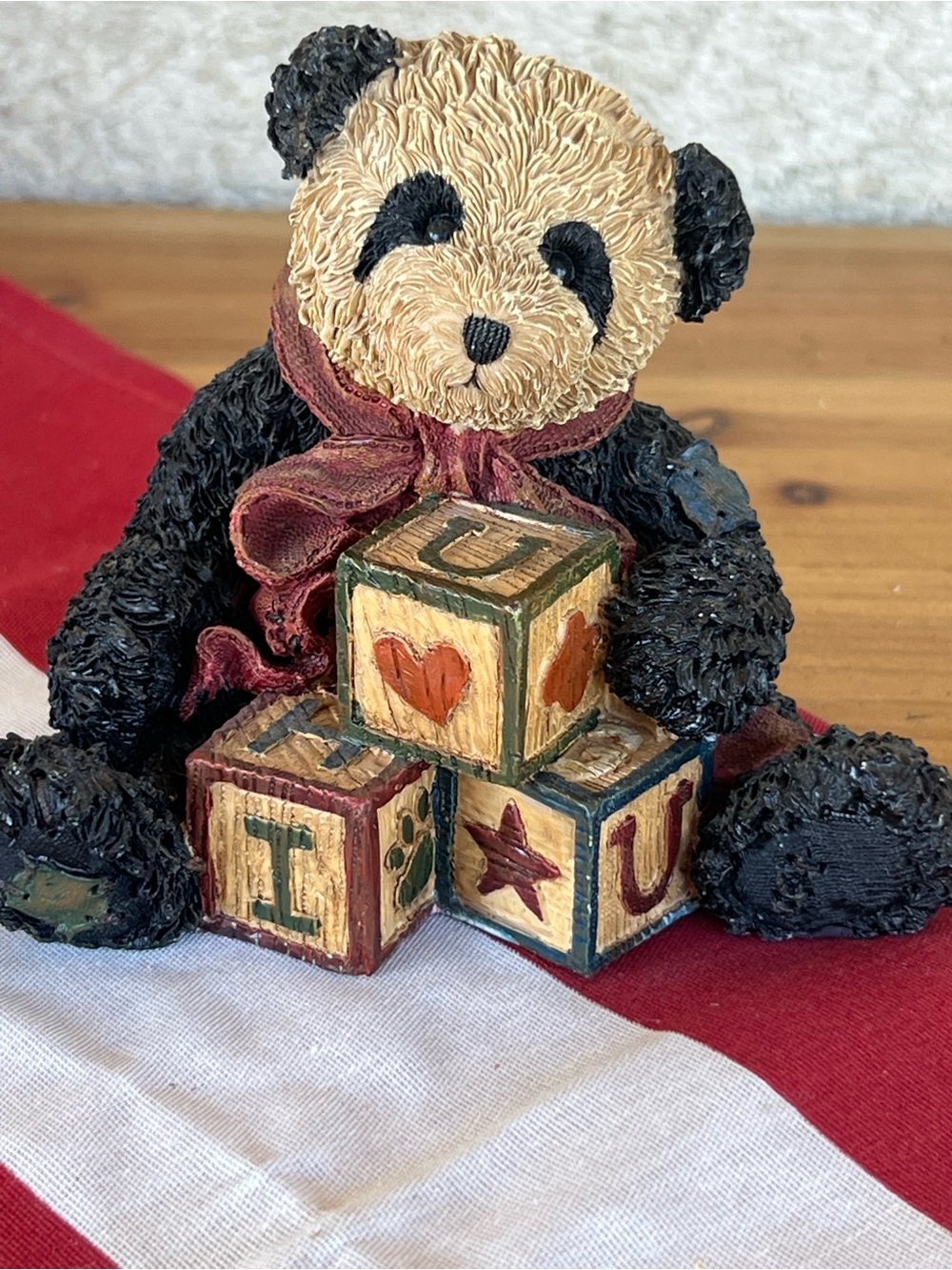 Adorable Black and Beige Panda Figurine with Burgundy Bow and Decorative Blocks
